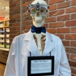 I promised the store clerk, Maria, at Kiehl’s in the Minneapolis airport that my staff would post at least one of the skeleton pics on whatever site the business card, # Follow Our Trial Frames takes people.  Mention her name and thank her for taping the TF on the “Doctor’s” head for me.